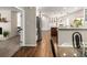 Open-concept kitchen leads to dining area with elegant finishes and stainless steel appliances, perfect for entertaining at 12662 W Asbury Pl, Lakewood, CO 80228