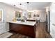 Beautiful kitchen with dark wood island and floors, granite countertops, stainless steel appliances, and abundant natural light at 12662 W Asbury Pl, Lakewood, CO 80228