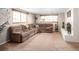 Spacious living room with a large sectional couch, windows, and decorative fireplace at 12662 W Asbury Pl, Lakewood, CO 80228