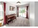 Inviting living room featuring a piano and sliding glass doors to a backyard patio at 12662 W Asbury Pl, Lakewood, CO 80228
