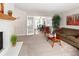 Cozy living room featuring a white brick fireplace and open doorway to the dining area at 12662 W Asbury Pl, Lakewood, CO 80228