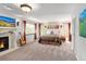 Spacious primary bedroom with a fireplace, natural light, warm decor, and a comfortable ambiance at 12662 W Asbury Pl, Lakewood, CO 80228