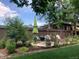 Landscaped backyard featuring outdoor dining beneath a large umbrella, ideal for gatherings at 2945 Grove St, Denver, CO 80211