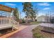 Backyard showcasing a brick patio, mature trees, and well-maintained lawn at 2945 Grove St, Denver, CO 80211