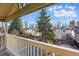 Balcony with view of trees, fenced yard and neighborhood at 2945 Grove St, Denver, CO 80211