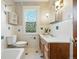 Charming bathroom features a custom window, vanity, and classic subway tile at 2945 Grove St, Denver, CO 80211