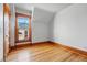 Bedroom featuring hardwood floors, trim, accent window and closet at 2945 Grove St, Denver, CO 80211