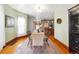 Traditional dining room featuring hardwood floors, vintage rug, period lighting, and bar access at 2945 Grove St, Denver, CO 80211