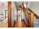 Traditional entryway with hardwood floors, staircase, and intricate wood trim detailing, offering a glimpse into other rooms at 2945 Grove St, Denver, CO 80211