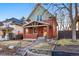 Attractive brick home with a covered porch, complemented by landscaping and a well-maintained yard in daylight at 2945 Grove St, Denver, CO 80211