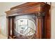 Close-up of the ornate wood mantel and mirror, showcasing the craftsmanship and vintage charm of this decorative fireplace at 2945 Grove St, Denver, CO 80211