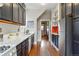 Well-lit kitchen offering stainless steel appliances, white countertops, and dark cabinets at 2945 Grove St, Denver, CO 80211