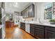 This kitchen features white countertops, dark cabinets, and an attached bar area for entertaining at 2945 Grove St, Denver, CO 80211