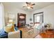 Inviting living room with hardwood floors, a decorative fireplace, comfortable seating, and an open doorway at 2945 Grove St, Denver, CO 80211