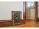 Ornate metal register contrasts with hardwood floors and wood trim in this charming home's interior at 2945 Grove St, Denver, CO 80211