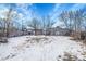 Large backyard with snow cover, offering ample outdoor space at 7111 Monaco St, Commerce City, CO 80022