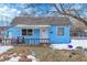 Charming blue bungalow with a covered porch and fenced yard at 7111 Monaco St, Commerce City, CO 80022