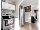 Kitchen with stainless steel appliances and white cabinetry at 7111 Monaco St, Commerce City, CO 80022