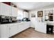 Kitchen with white cabinets, stainless steel appliances, and mosaic backsplash at 7111 Monaco St, Commerce City, CO 80022