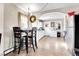 Kitchen with white cabinets, a breakfast bar, and stainless steel appliances at 7111 Monaco St, Commerce City, CO 80022