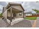 Backyard with a covered patio offering a view of the green lawn, gravel landscape, and home exterior at 7442 Greenwater Cir, Castle Rock, CO 80108