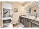 Beautiful bathroom with a granite countertop vanity area adjacent to the bedroom for convenient access at 7442 Greenwater Cir, Castle Rock, CO 80108