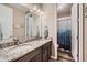 Bright bathroom with dual granite countertop sinks and a separate enclosed toilet and shower area at 7442 Greenwater Cir, Castle Rock, CO 80108