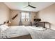Cozy bedroom with neutral tones, a ceiling fan, modern decor, and a dedicated workspace for comfort and functionality at 7442 Greenwater Cir, Castle Rock, CO 80108