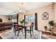 A naturally lit dining area with wood table, chandelier, and sliding glass doors leading to an outdoor space at 7442 Greenwater Cir, Castle Rock, CO 80108