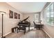 Versatile room featuring a baby grand piano and a desk area, perfect for use as an office or music room at 7442 Greenwater Cir, Castle Rock, CO 80108