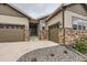 Attractive home with a three-car garage, stone accents, and a cozy front entrance; great curb appeal at 7442 Greenwater Cir, Castle Rock, CO 80108