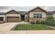 Inviting home with a landscaped lawn, stone accents, and a two-car garage, perfect for suburban living at 7442 Greenwater Cir, Castle Rock, CO 80108