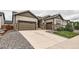 Charming two-story home with stone accents, a two-car garage, and meticulously maintained landscaping at 7442 Greenwater Cir, Castle Rock, CO 80108