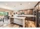A spacious kitchen featuring stainless steel appliances, an island, granite countertops, and dark wood cabinets at 7442 Greenwater Cir, Castle Rock, CO 80108