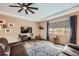 Cozy living room featuring a modern ceiling fan, large window, and comfortable seating arrangement at 7442 Greenwater Cir, Castle Rock, CO 80108