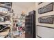 Walk-in pantry featuring wire shelving and organization, plus an additional full-sized refrigerator for extra storage at 7442 Greenwater Cir, Castle Rock, CO 80108