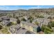 A vibrant community of townhomes with attached garages nestled amidst lush landscaping and picturesque mountain views at 835 Stony Mesa Pl, Castle Rock, CO 80108