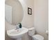 Neat half bathroom showcasing a pedestal sink, round mirror, and neutral tones at 835 Stony Mesa Pl, Castle Rock, CO 80108