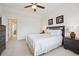 Comfortable bedroom offers a spacious layout with a ceiling fan, neutral walls, and carpet at 835 Stony Mesa Pl, Castle Rock, CO 80108
