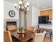 Open-concept dining space showcasing a fireplace and seamless access to the kitchen at 835 Stony Mesa Pl, Castle Rock, CO 80108