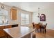 Well-lit dining area features a chandelier, hardwood floors, and a charming window at 835 Stony Mesa Pl, Castle Rock, CO 80108