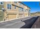 Row of attached garages in townhome community on sunny day at 835 Stony Mesa Pl, Castle Rock, CO 80108