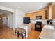 Efficient kitchen design with a breakfast bar, pantry, and modern black appliances at 835 Stony Mesa Pl, Castle Rock, CO 80108