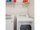 Laundry room features a washer, dryer and a metal shelf at 835 Stony Mesa Pl, Castle Rock, CO 80108