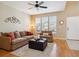 Bright living room boasts lots of natural light, comfortable seating, and hardwood floors at 835 Stony Mesa Pl, Castle Rock, CO 80108