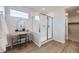 Contemporary bathroom featuring a glass-enclosed shower, stylish vanity, and wood-look flooring at 4096 Estrella St, Brighton, CO 80601