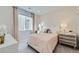 Cozy bedroom featuring charming decor, a large window, and pink accents at 4096 Estrella St, Brighton, CO 80601