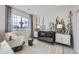 Inviting Bedroom featuring a stylish crib, mural wallpaper, comfortable seating, and a large window with a view at 4096 Estrella St, Brighton, CO 80601