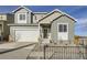 Charming two-story home featuring a two car garage, inviting entrance, and tasteful landscaping at 4096 Estrella St, Brighton, CO 80601