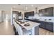 Modern kitchen with stainless steel appliances, a large island with seating, and ample cabinet space at 4096 Estrella St, Brighton, CO 80601